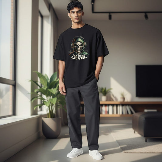 Adult wearing black gaming t shirt with green skull and headset