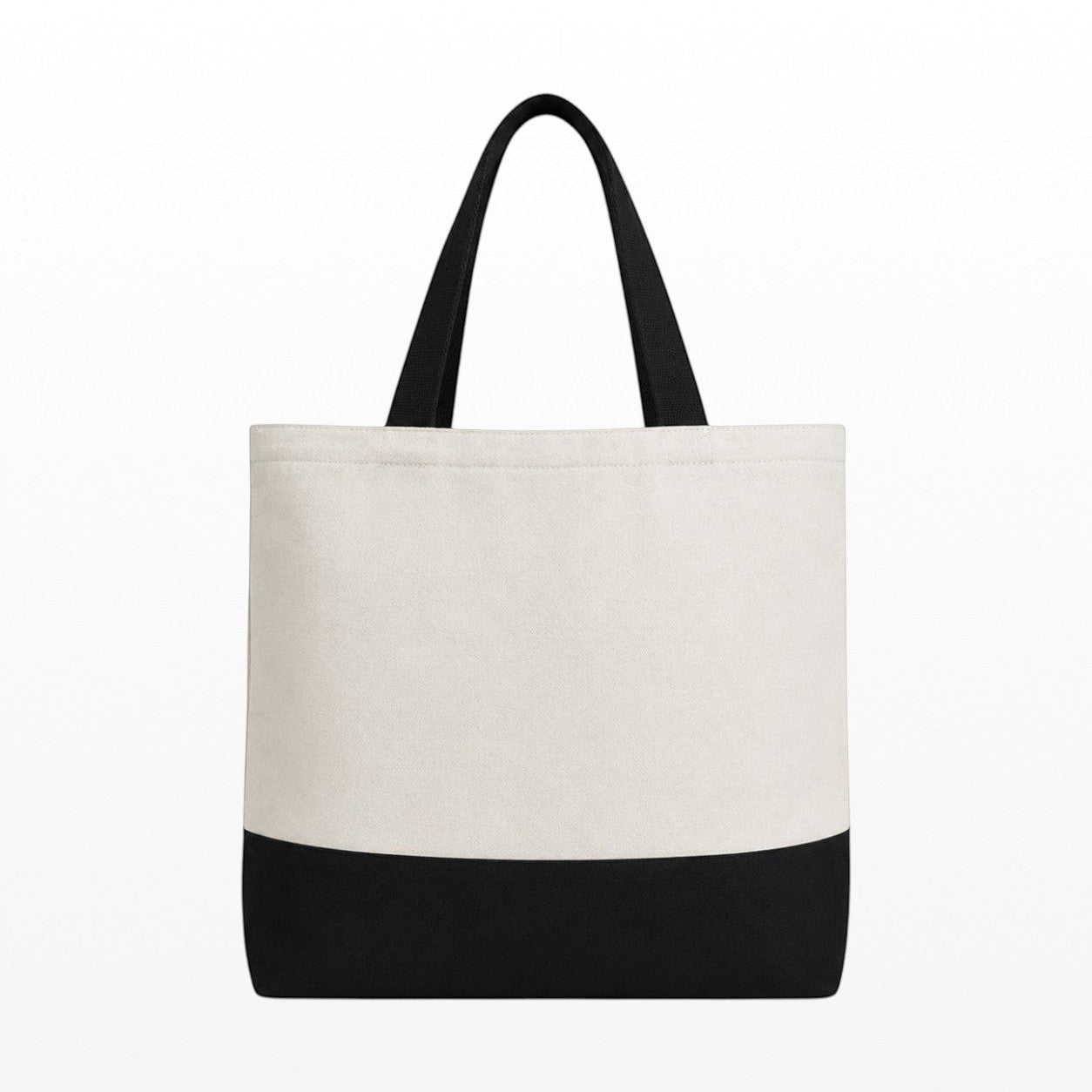 Tote bag with black bottom half and white top half on a white background