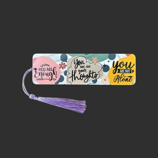 Illustrated Solutions Store metal bookmark with colourful affirmation quotes and a purple tassel for book lovers.
