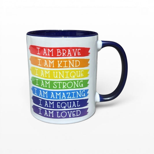 Illustrated Solutions Store white mug with rainbow stripes and affirmations like "I am Brave, I am Kind, I am Unique."