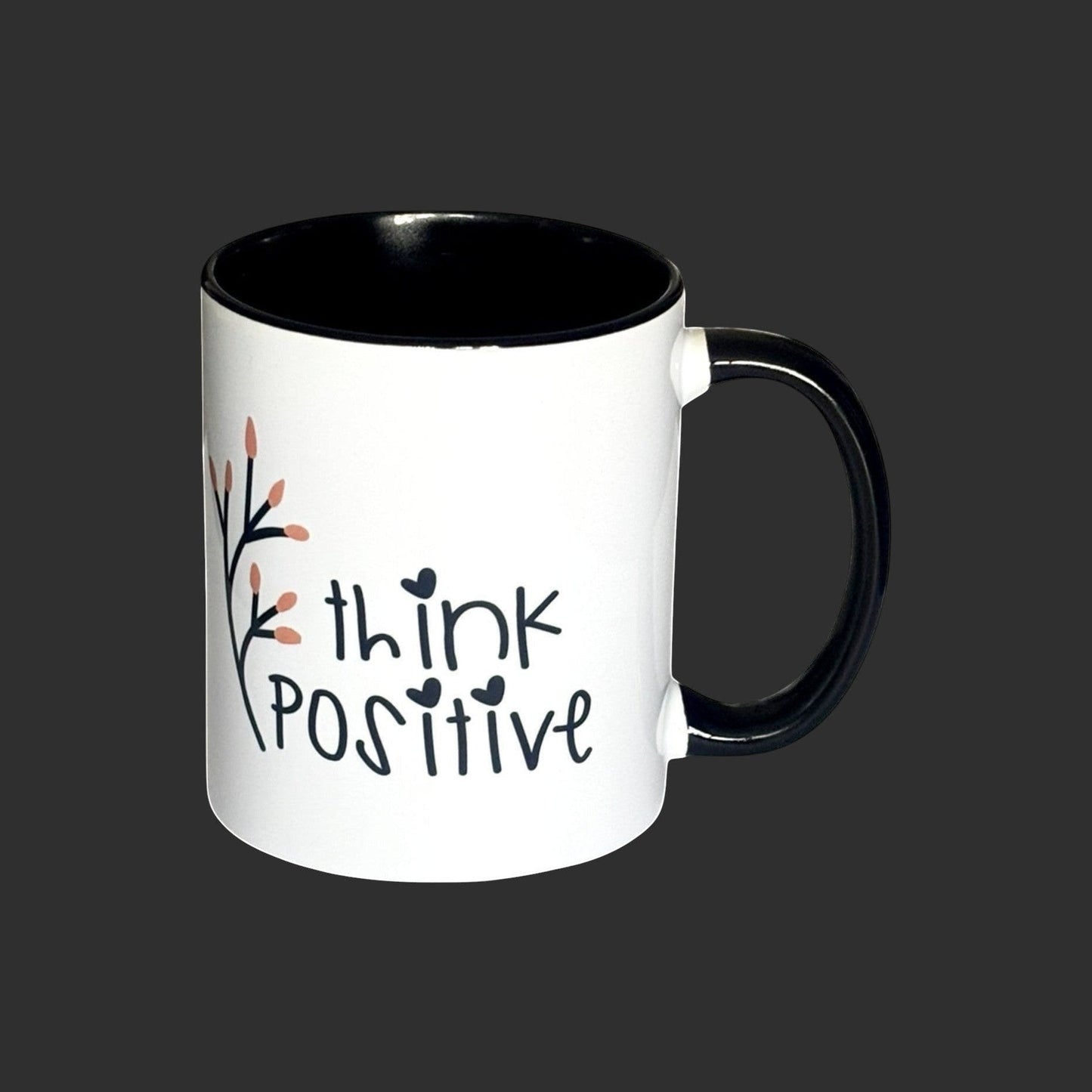 White ceramic mug with black interior and handle, featuring 'think positive' text and floral design. Right side view.