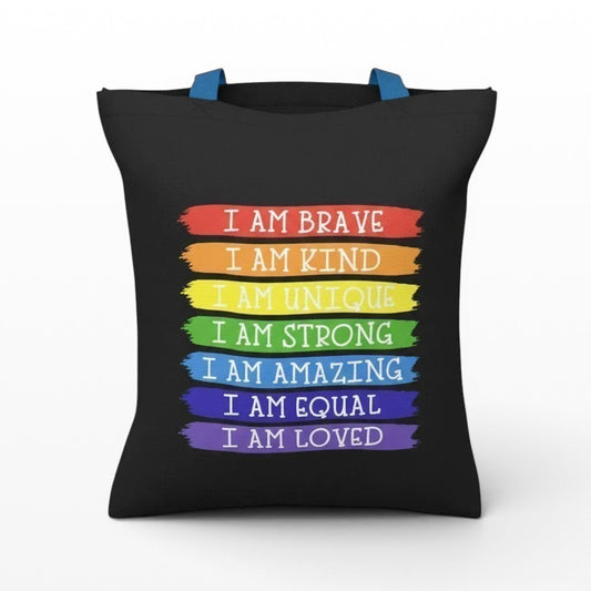 Illustrated Solutions Store black tote bag with rainbow stripes featuring affirmations like "I Am Brave" and "I Am Loved".