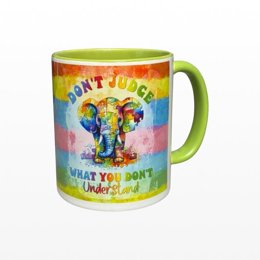 Illustrated Solutions Store 11oz ceramic mug with lime green handle featuring a colourful puzzle piece elephant design