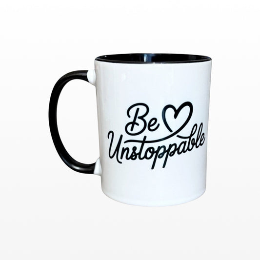 Illustrated Solutions Store white ceramic mug with black handle and interior, featuring the motivational phrase "Be Unstoppable" in black script.