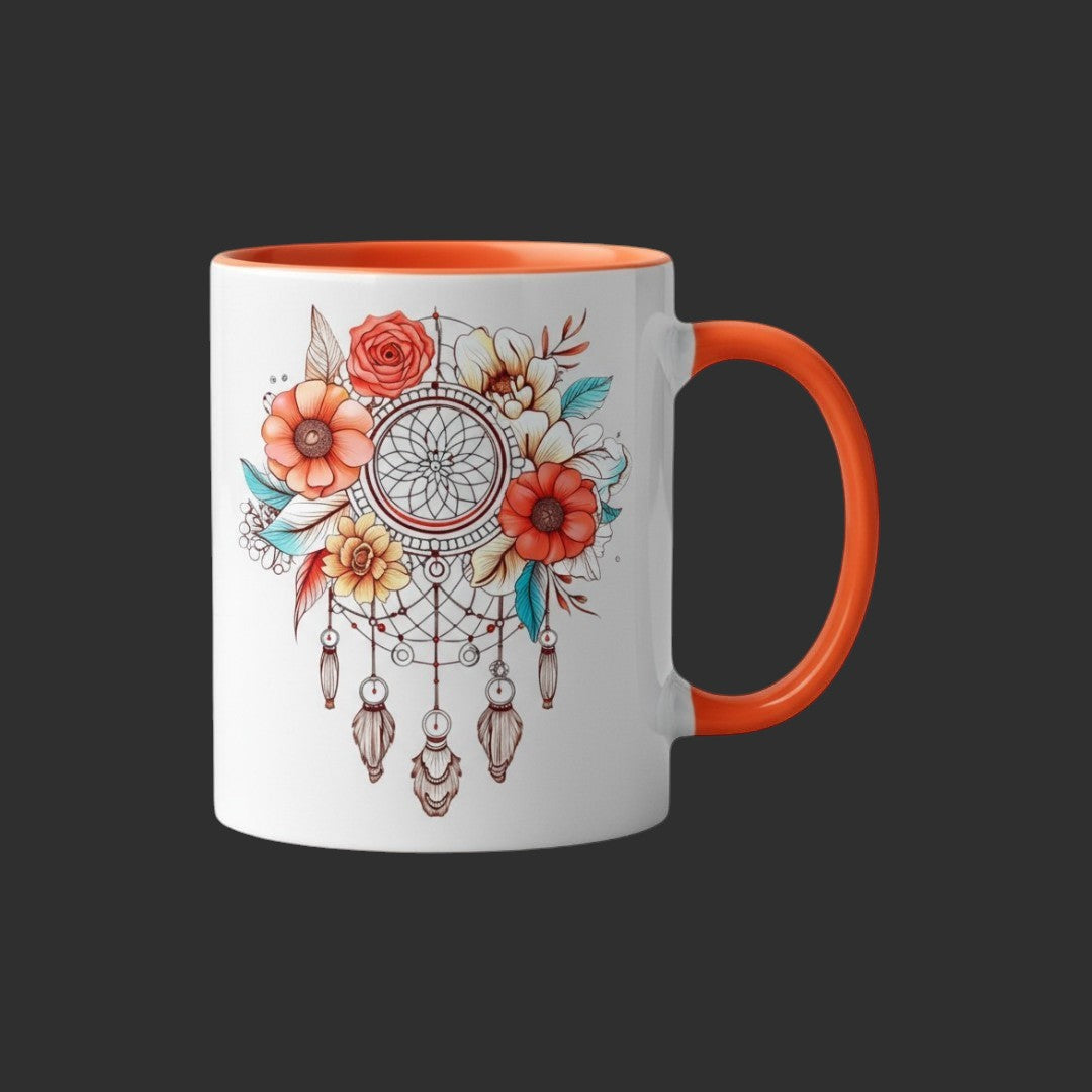 Illustrated Solutions Store 11oz ceramic mug with a boho floral dreamcatcher design and orange handle and rim.