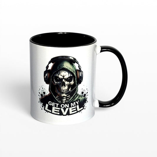 Illustrated Solutions Store white ceramic mug with black handle and interior, featuring a skull gamer design with headset and the text "Get On My Level".