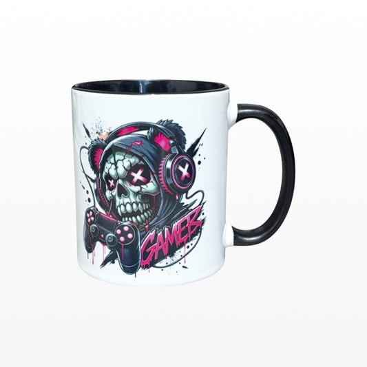 Illustrated Solutions Store white ceramic mug with black handle, featuring a skull gamer design with pink headphones and controller.