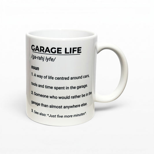 Illustrated Solutions Store white ceramic mug featuring a Garage Life dictionary definition for car enthusiasts.