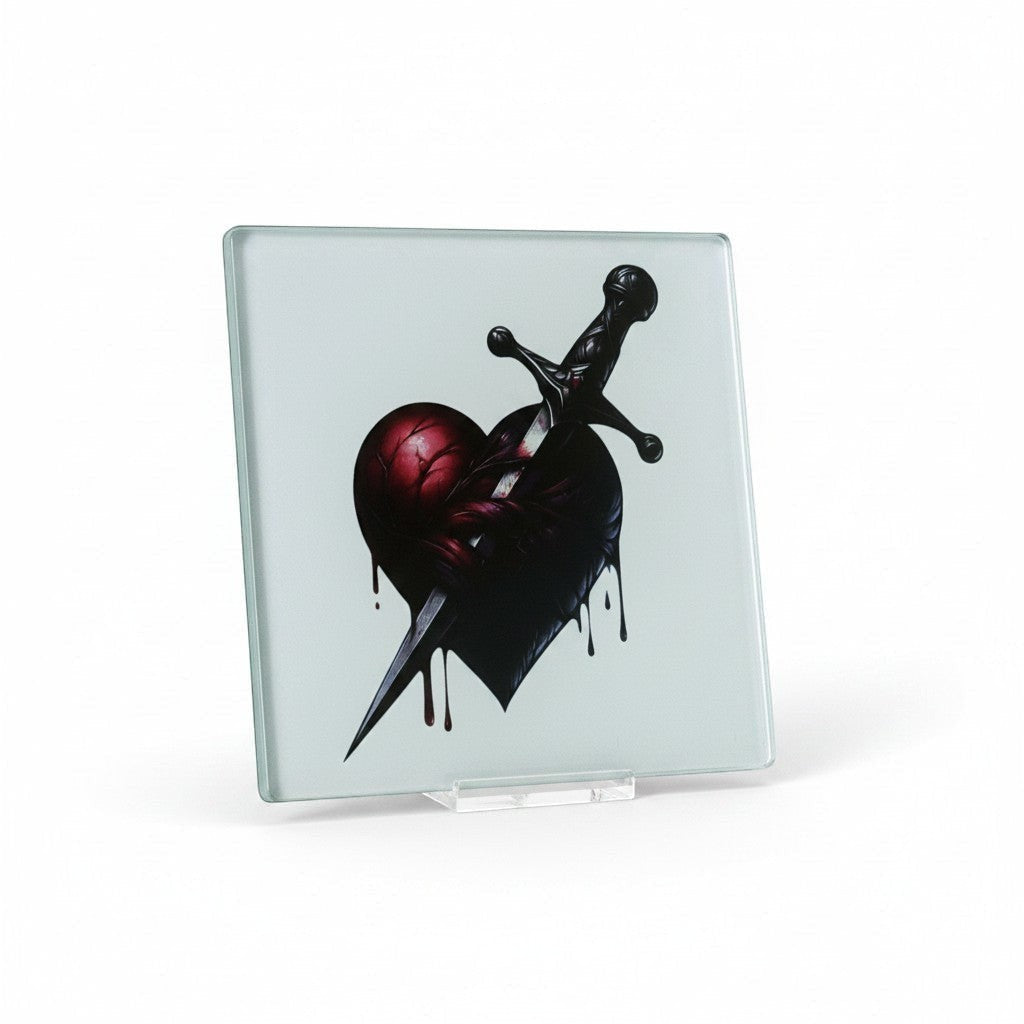Illustrated Solutions Store gothic glass coaster with a dark red heart pierced by a black dagger, dripping blood.