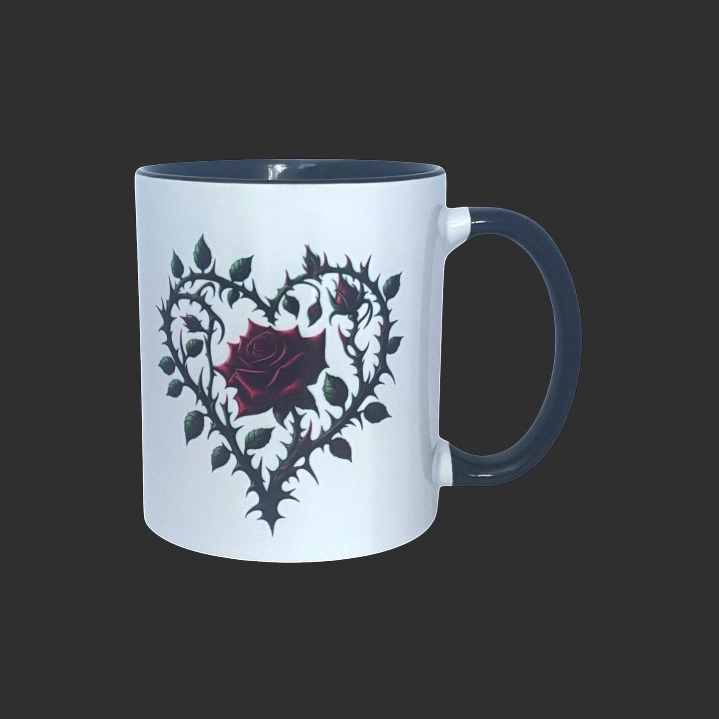 White mug with a black heart design featuring a red rose on a black background