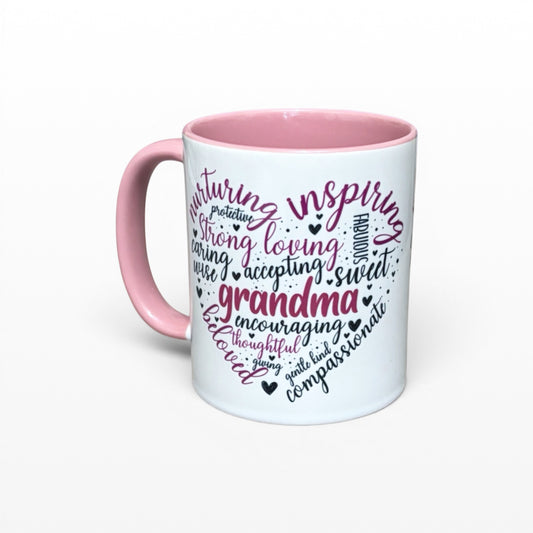Illustrated Solutions Store white ceramic mug with pink handle and interior, featuring a heart-shaped word cloud with 'Grandma' at the center, surrounded by loving adjectives.