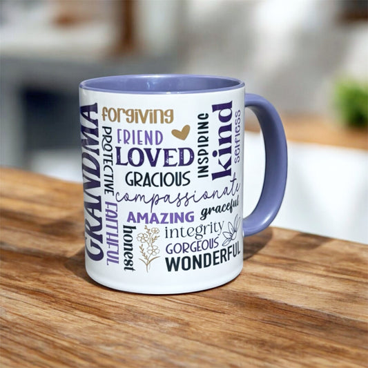 Illustrated Solutions Store white ceramic mug with purple interior and handle, featuring the word "Grandma" vertically and a word cloud of positive adjectives like "loved," "kind," and "amazing."
