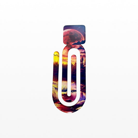 Illustrated Solutions Store Into The Woods acrylic book clip featuring a vibrant sunset forest and moon design.