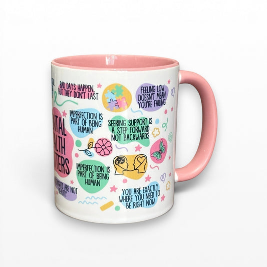Illustrated Solutions Store mental health matters mug with pink handle and interior, featuring uplifting messages and colourful illustrations.