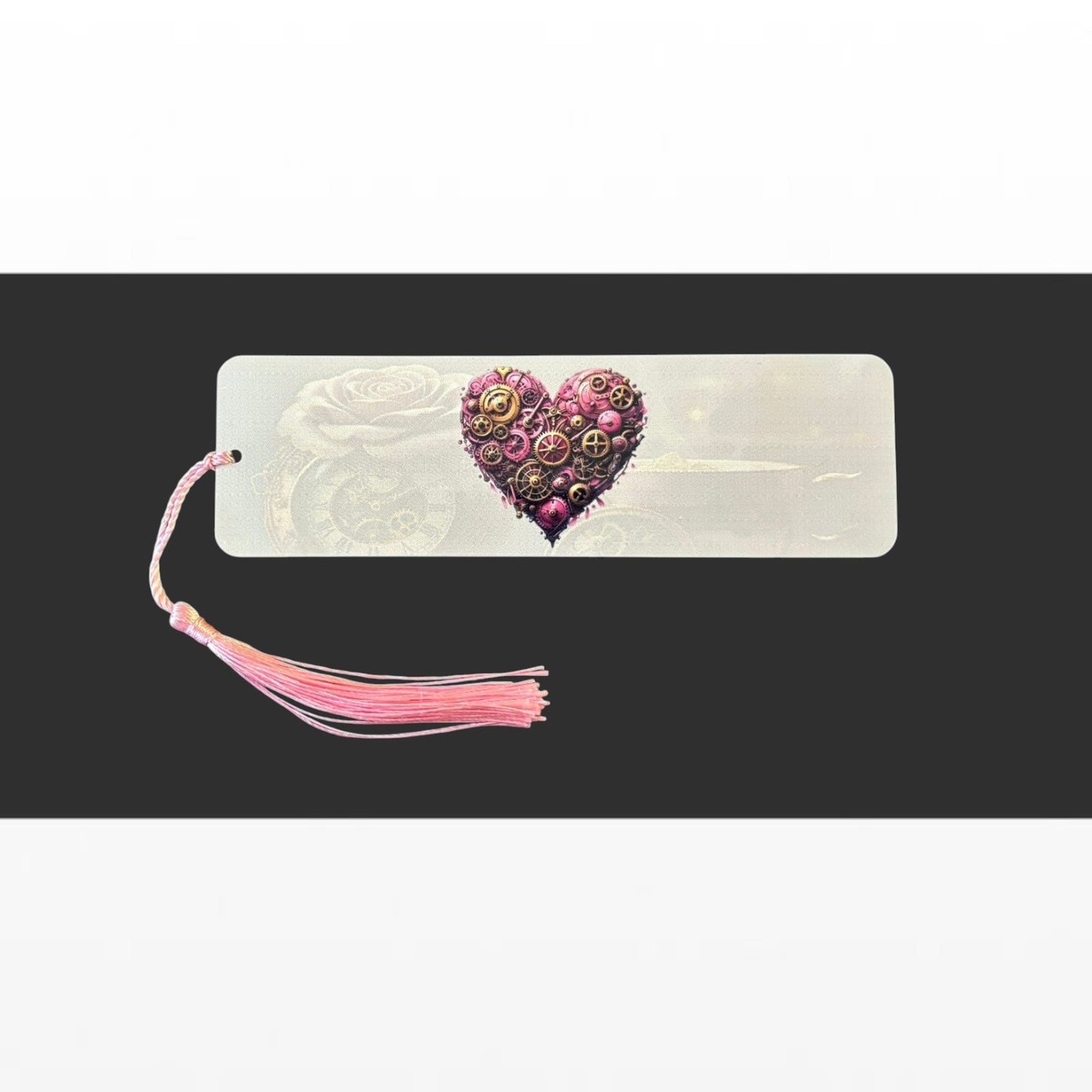 Illustrated Solutions Store pink heart steampunk metal bookmark with intricate gear details and a matching pink tassel.