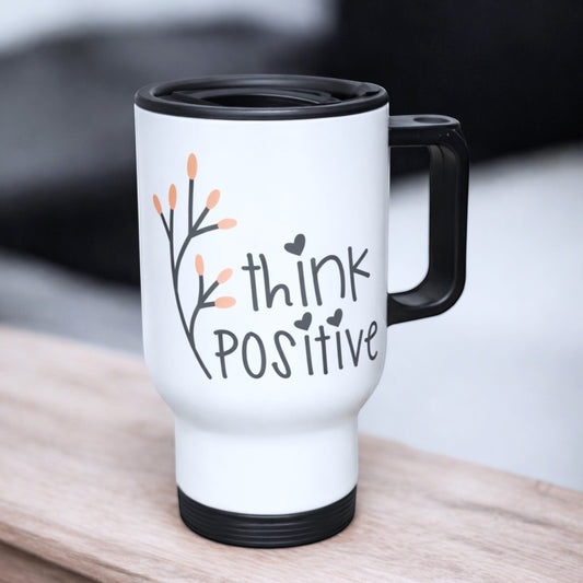 Illustrated Solutions Store white travel mug with black handle, featuring "think POSITIVE" text and a floral branch design.