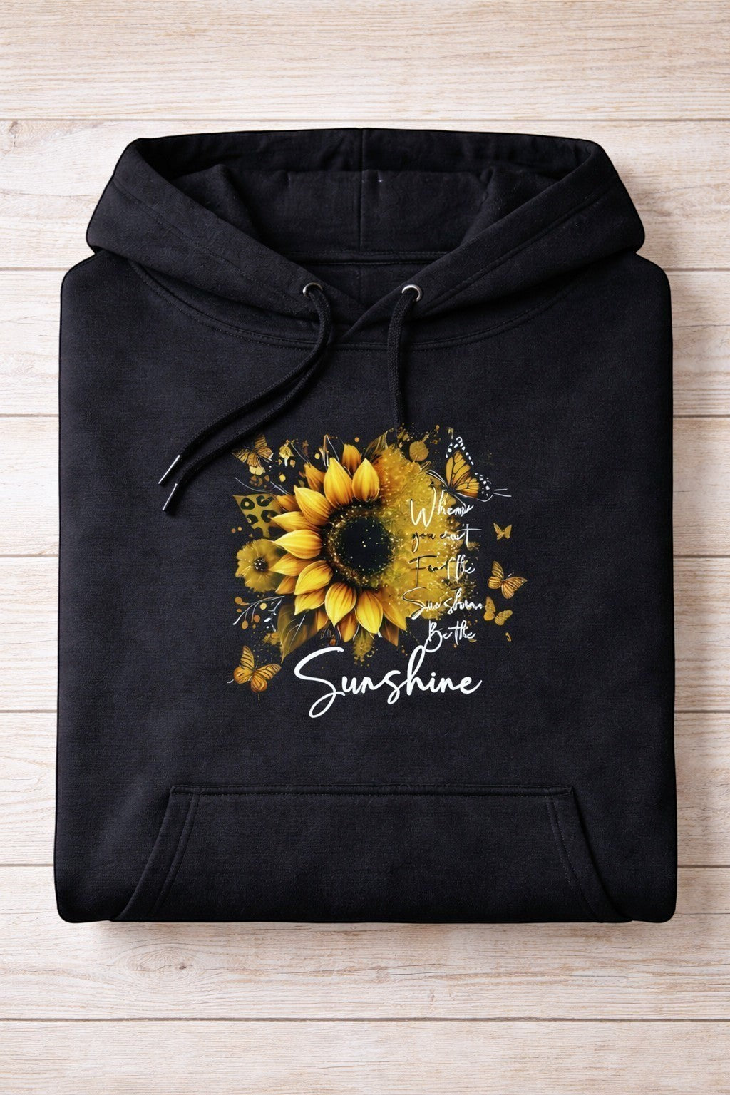 Folded view of Be the Sunshine Black Hoodie hand-pressed in the UK