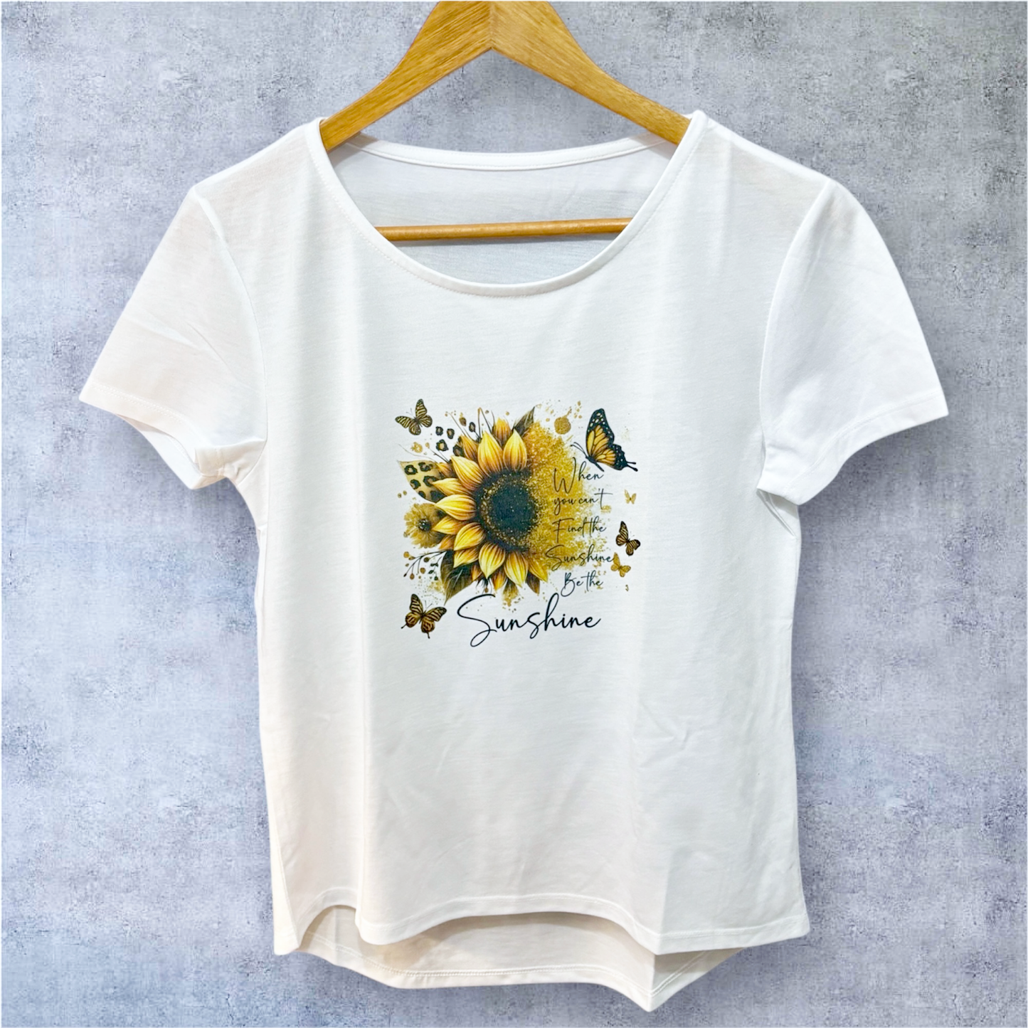 white t-shirt on hanger with be the sunshine text and image hand printed UK