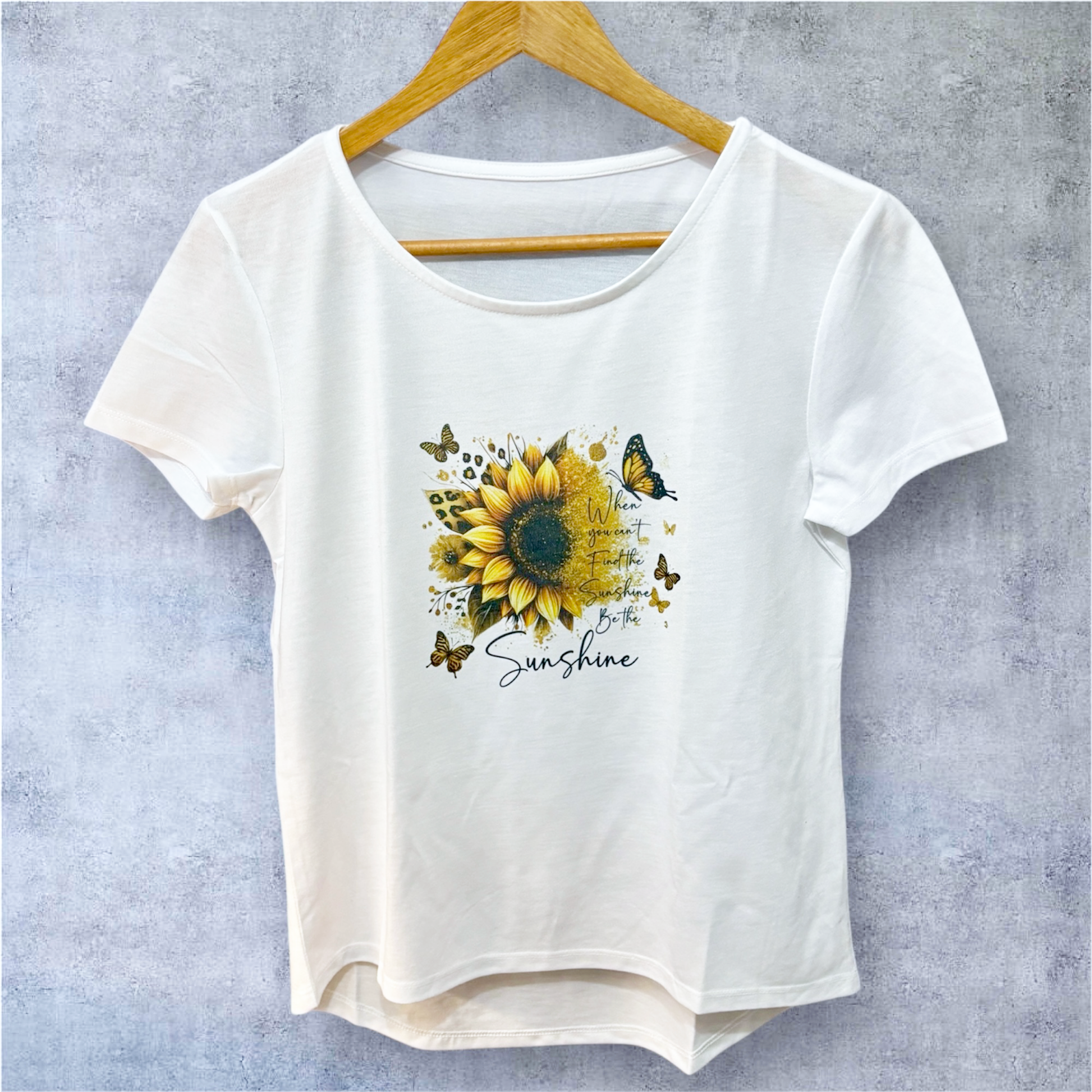 white t-shirt on hanger with be the sunshine text and image hand printed UK