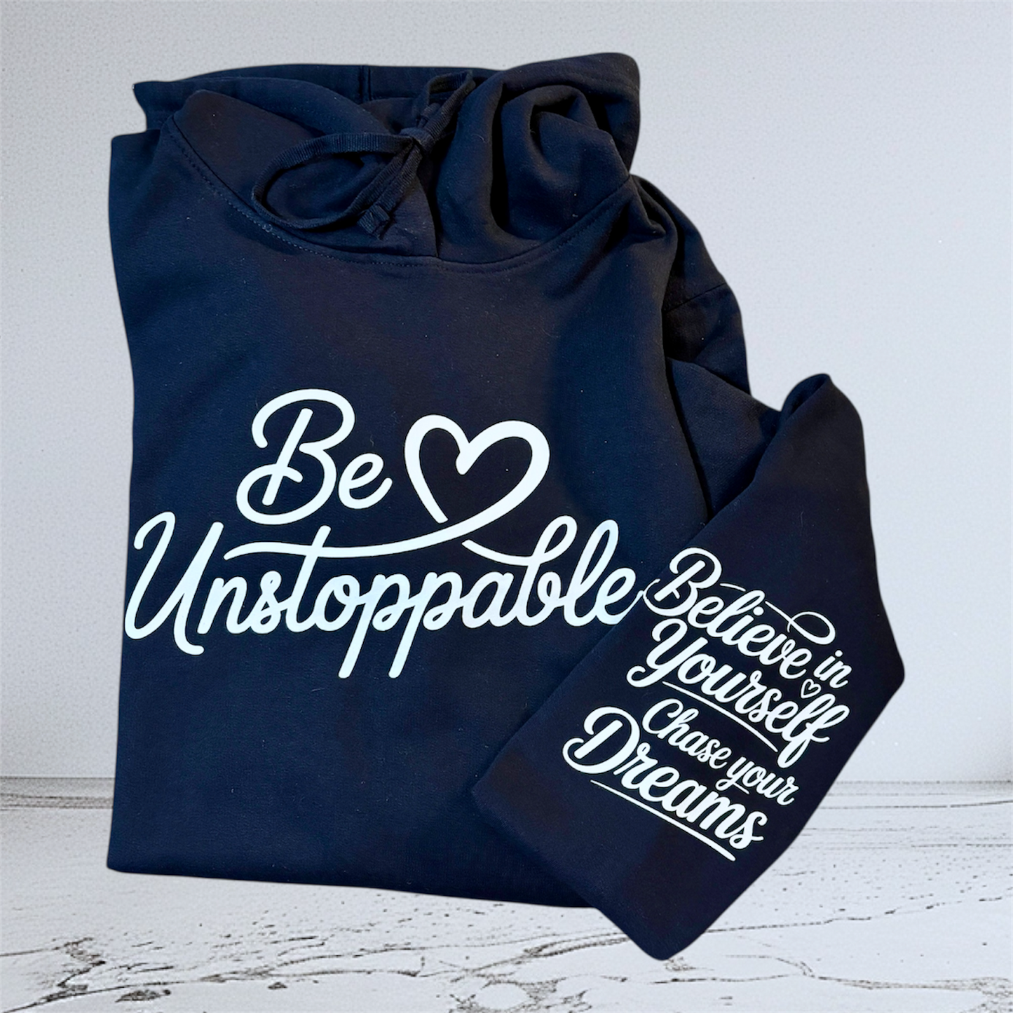 Close up of Be Unstoppable navy hoodie hand pressed UK