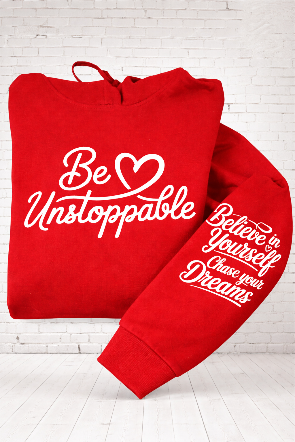 Close up of Be Unstoppable red hoodie with bold motivational text printed on front hand pressed UK