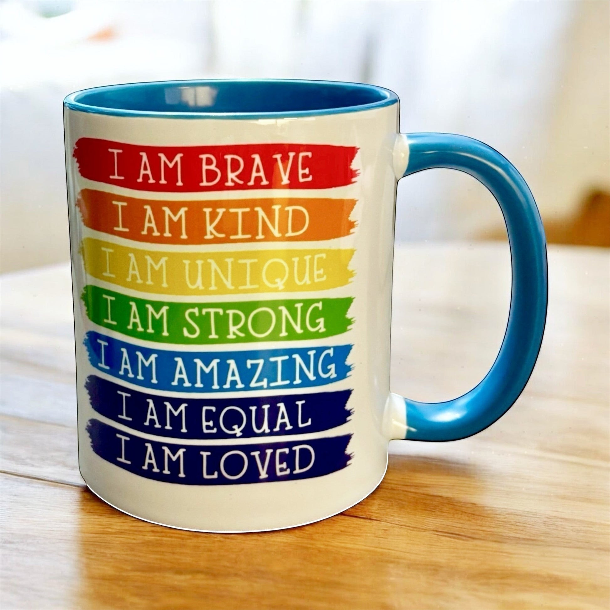 Light Blue Mug with motivational phrases in rainbow colours hand printed in the UK