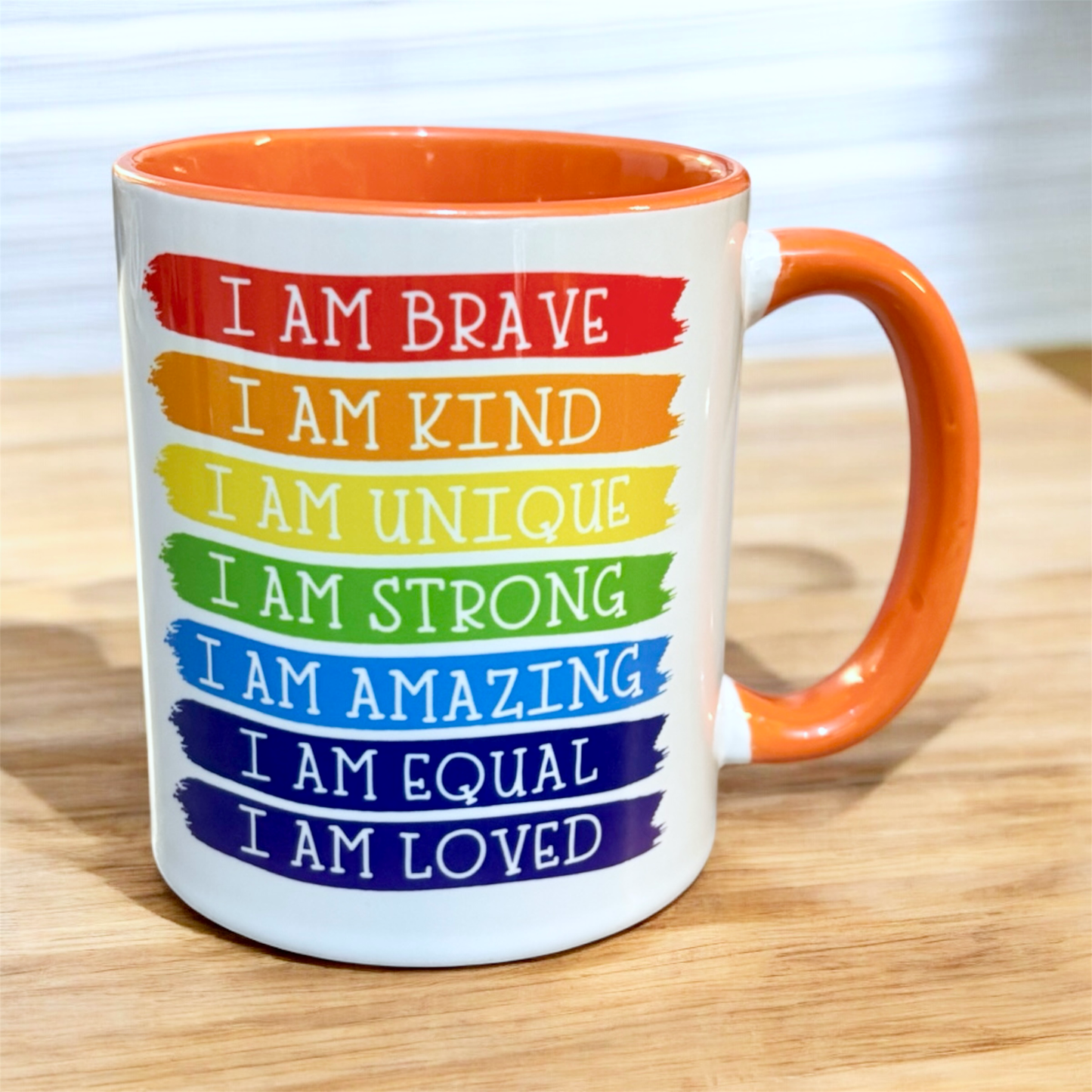 hand printed in the UK 2 tone inner and handle orange Mug with motivational phrases in striking rainbow colours