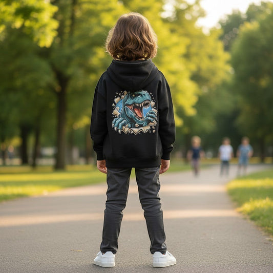 Child wearing blue trex on back of hoodie stood in park