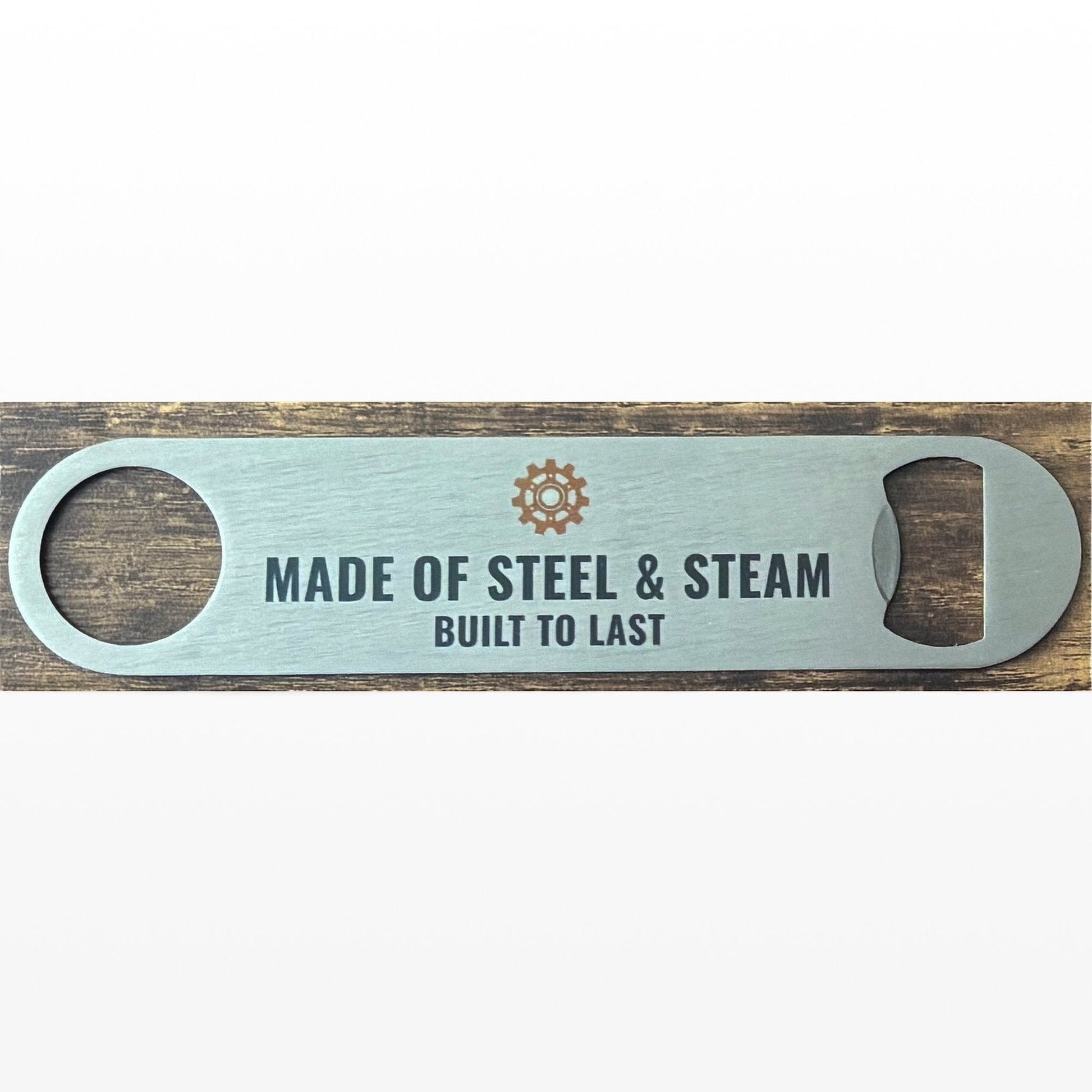 Stainless Steel Bar Blade with Steampunk Cog and Made of Steel & Steem Text in black. Bar blade on wooden table.