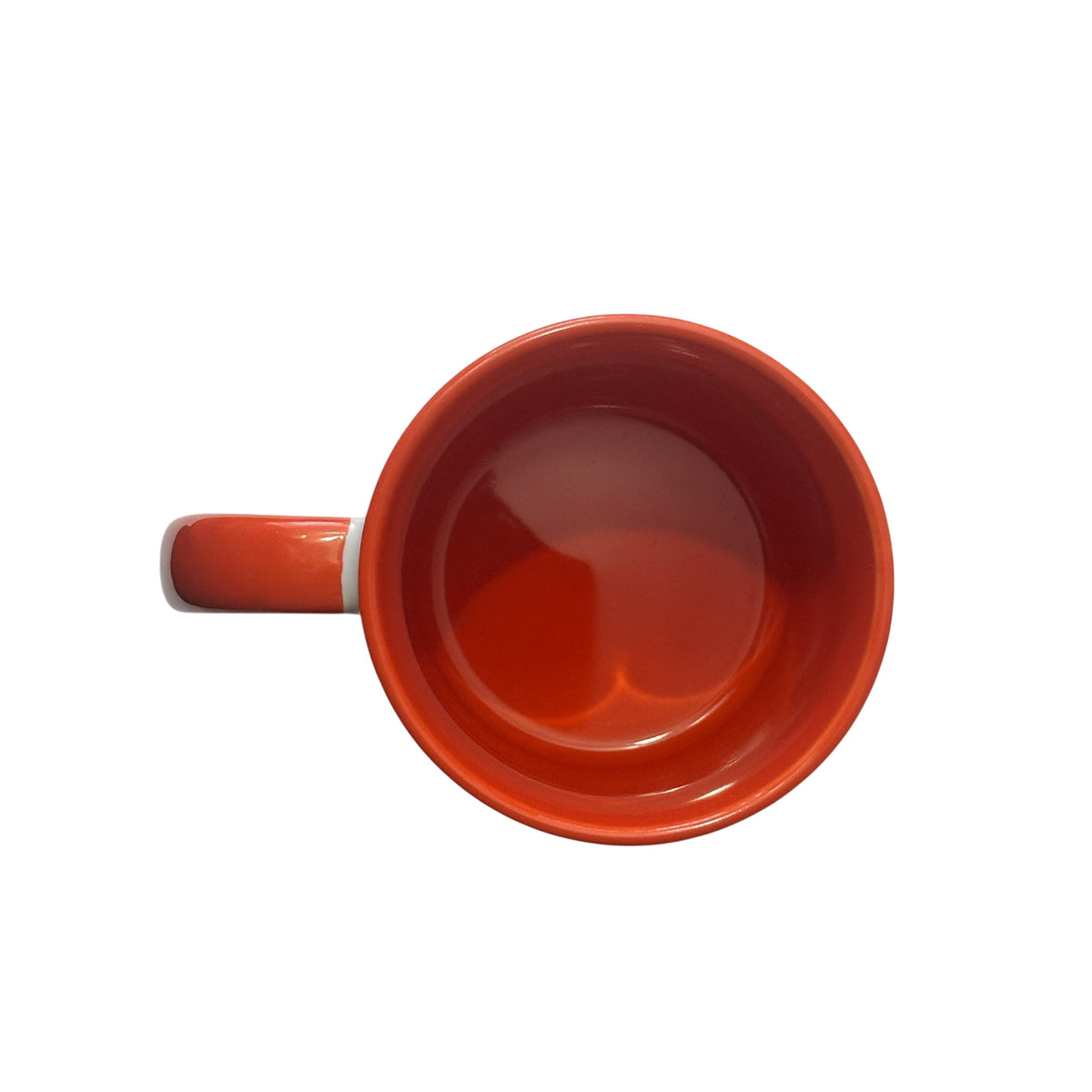 A top-down view of a glossy ceramic mug in a vibrant orange colour, showing the orange handle on the left and a smooth orange interior surface, isolated on a white background.