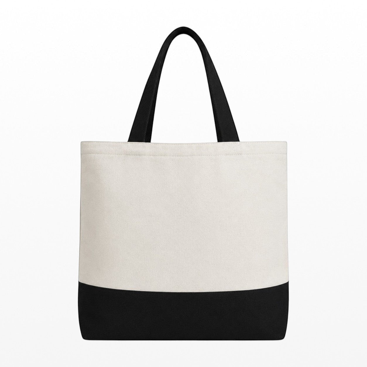 Tote bag with black bottom half and white top half on a white background