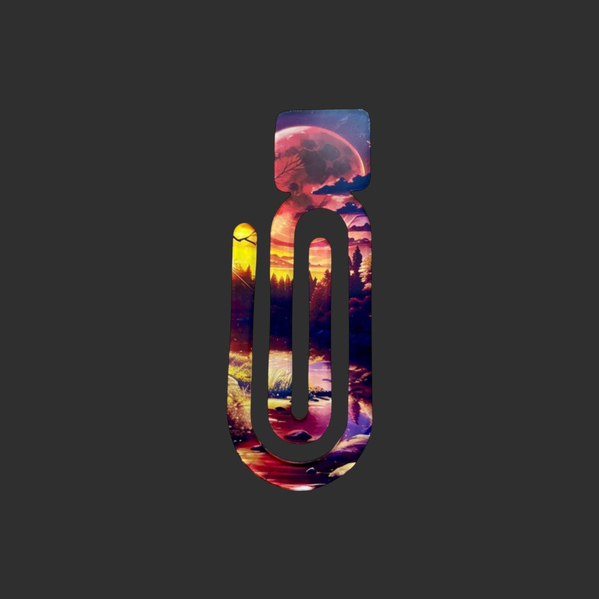 A perfect literary gift of an acrylic book clip featuring a vibrant Into The Woods sunset forest landscape design.