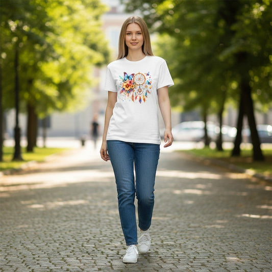 Woman walking on a tree-lined street wearing a white t-shirt with a colorful graphic design.