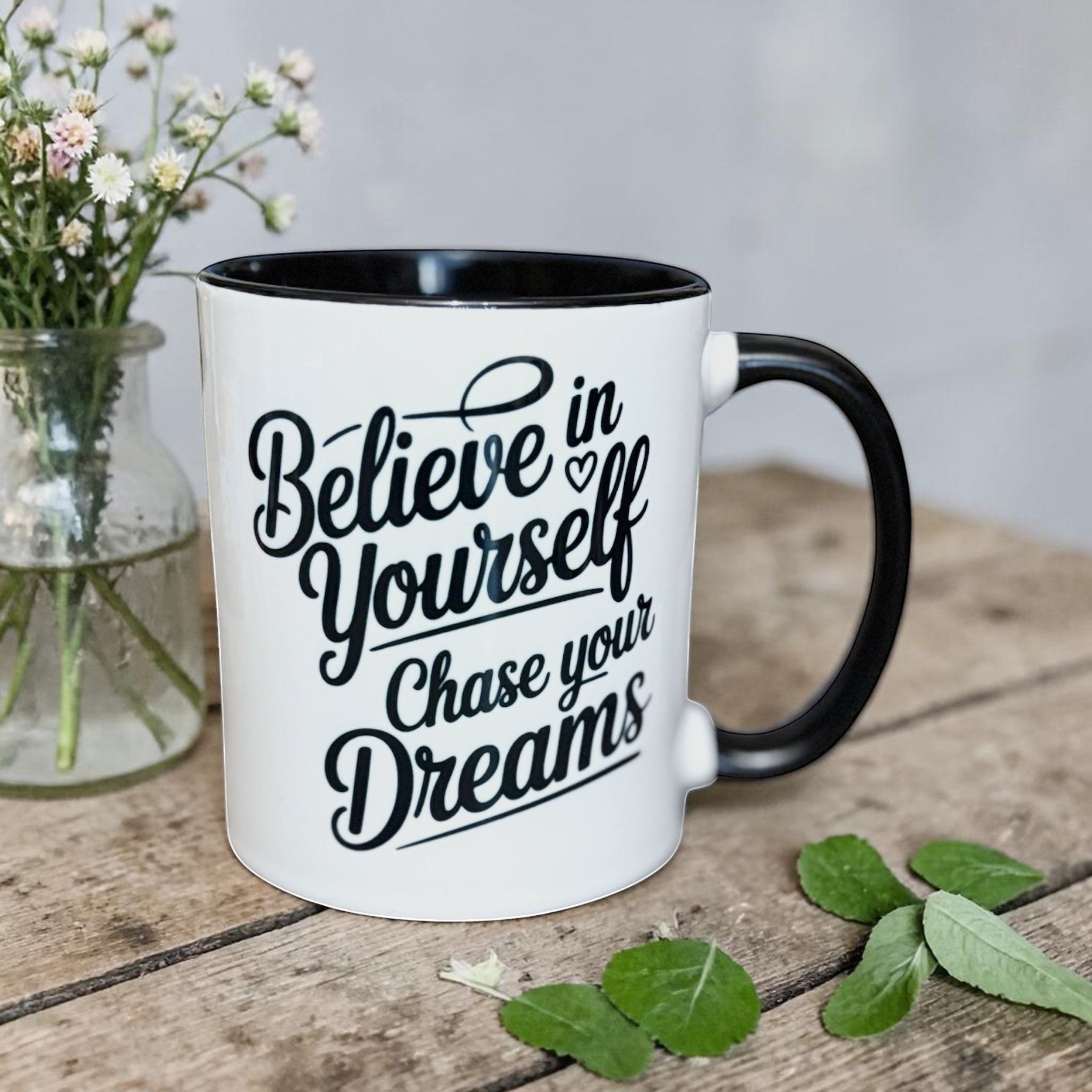 Illustrated Solutions Store white ceramic mug with black interior and handle, featuring black text: Believe in Yourself, Chase your Dreams.