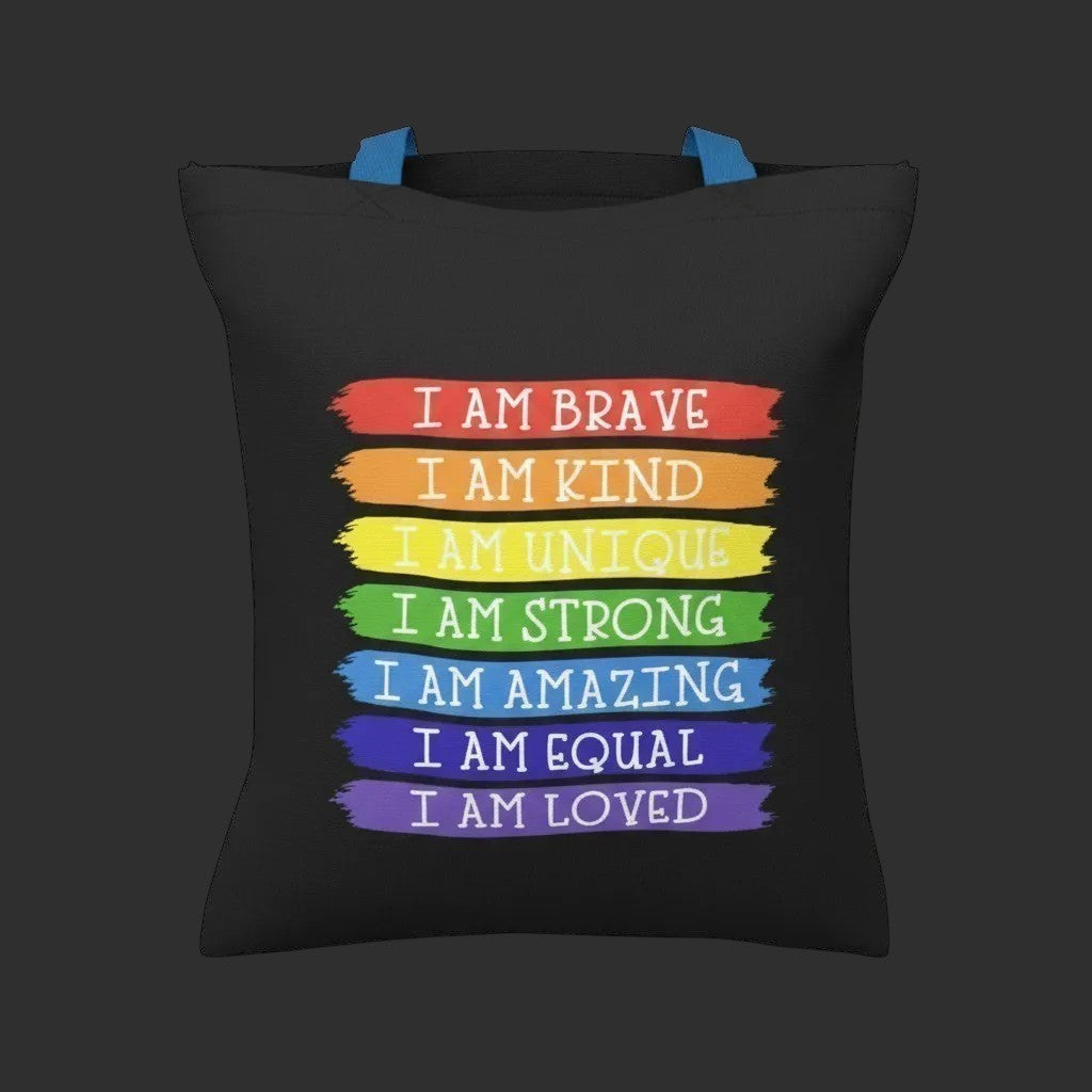 Illustrated Solutions Store black tote bag with rainbow stripes featuring affirmations like "I Am Brave" and "I Am Loved".