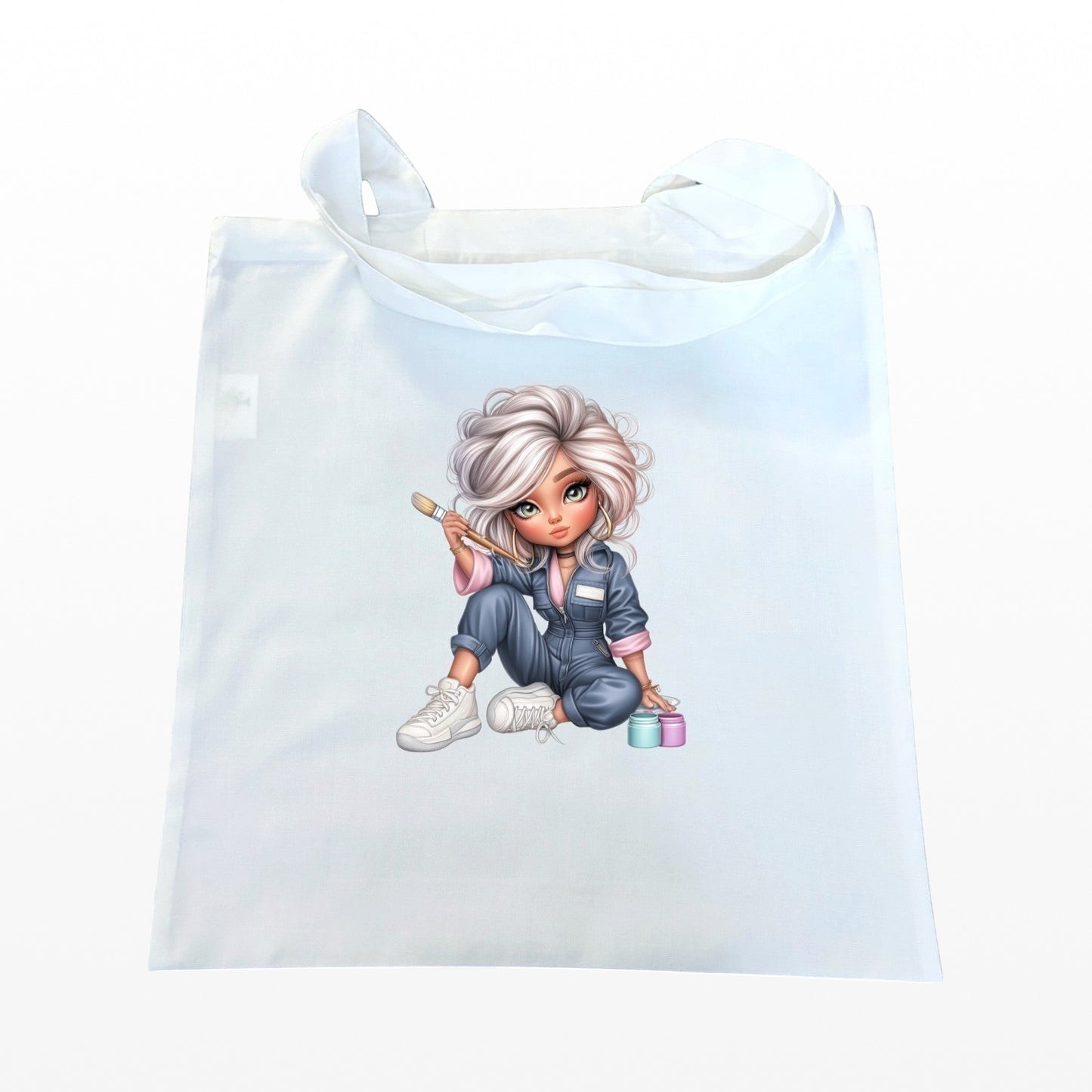 Illustrated Solutions Store white reusable tote bag featuring a cute artist character with a paintbrush and paint pots.