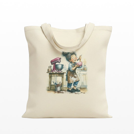 Illustrated Solutions Store cream canvas tote bag with a baking girl illustration, pink stand mixer, and kitchen counter.