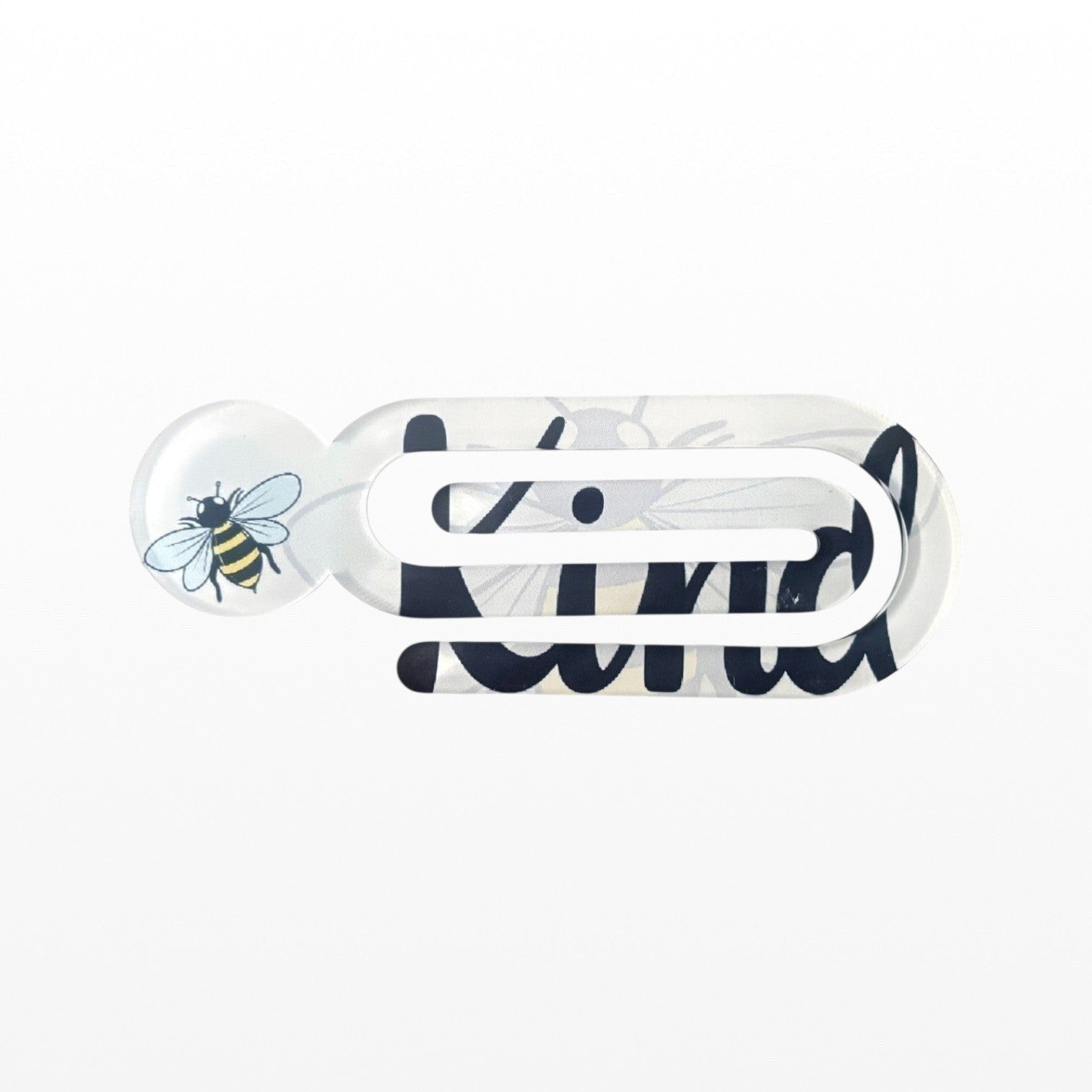 Illustrated Solutions Store acrylic book clip featuring a bee design and the Bee Kind message on a white background