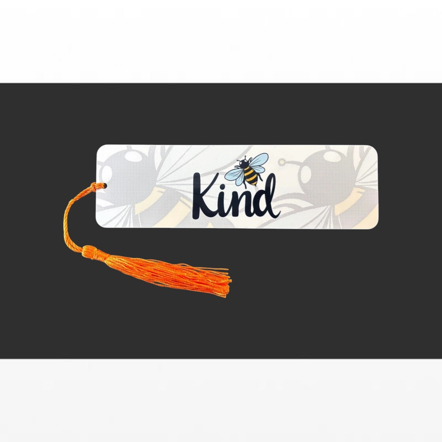 Illustrated Solutions Store metal bookmark with Bee Kind text, bumblebee illustration, and orange tassel.