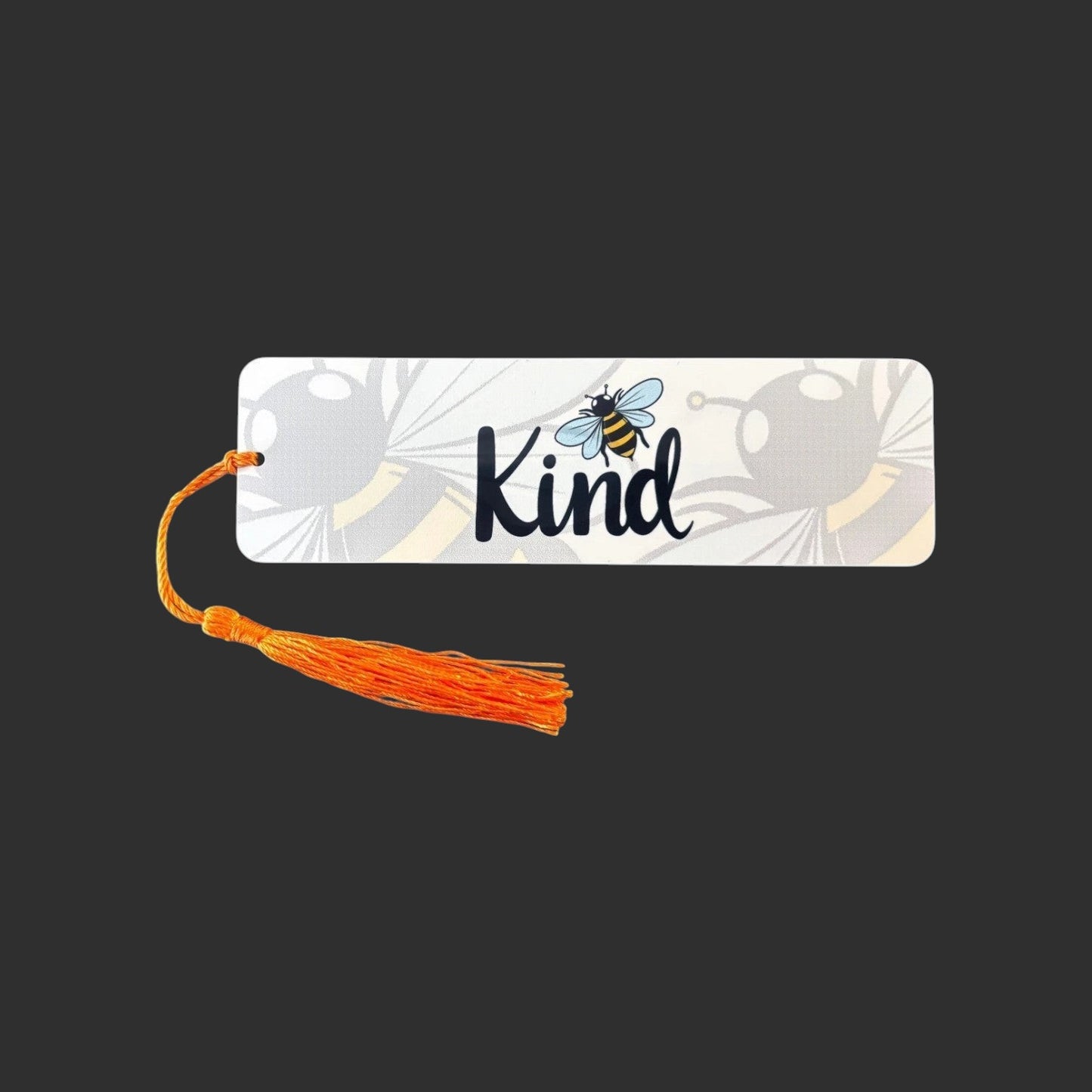 Illustrated Solutions Store metal bookmark with Bee Kind text, bumblebee illustration, and orange tassel.
