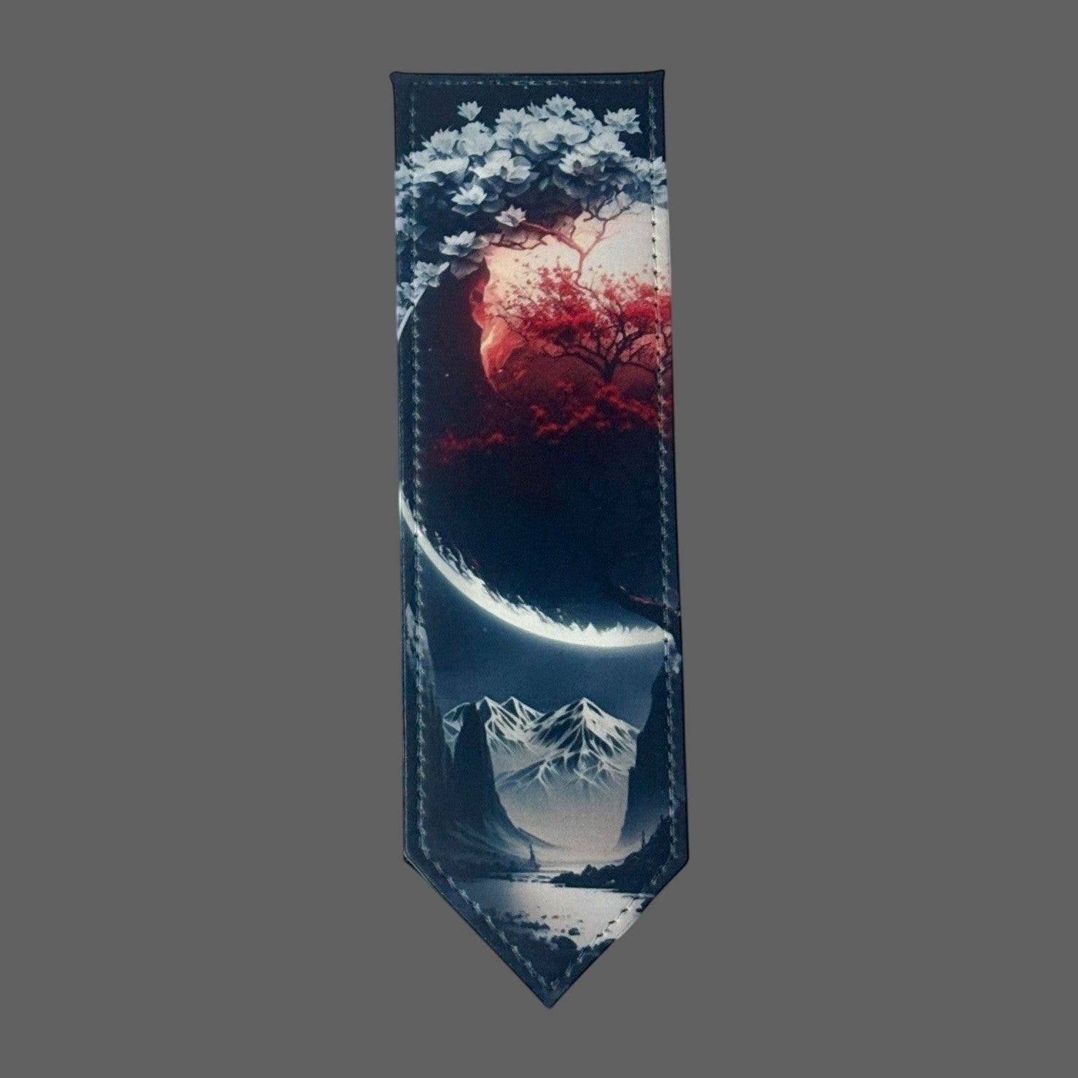 Illustrated Solutions Store leather bookmark with crimson moon over mountains and snowy peaks.