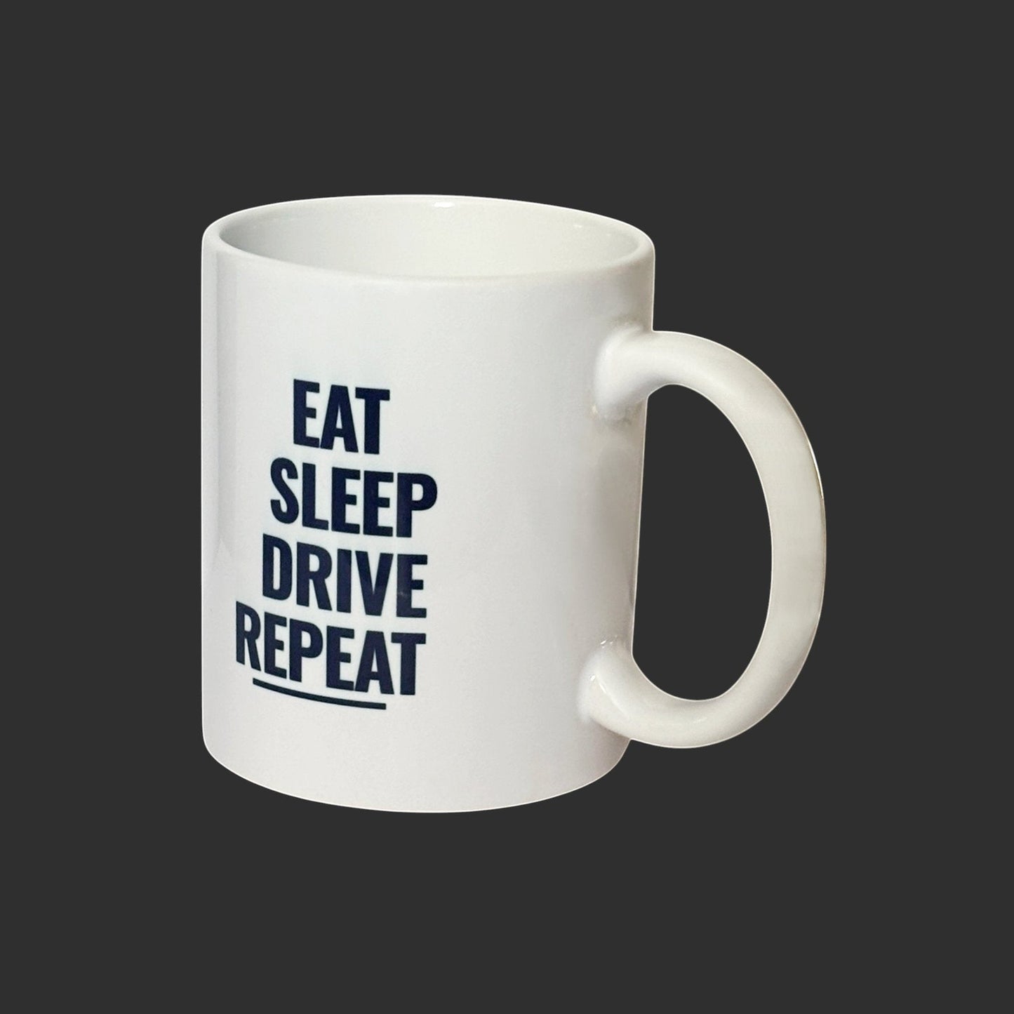 Illustrated Solutions Store white ceramic mug with navy blue text reading 'EAT SLEEP DRIVE REPEAT' and a line underneath.
