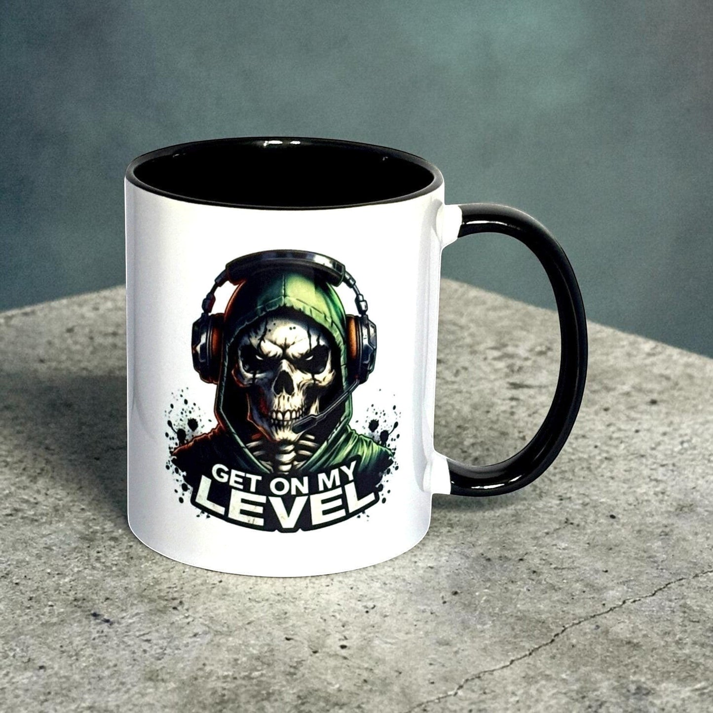 Illustrated Solutions Store white ceramic mug with black interior and handle, featuring a skull gamer design with headset and the text Get On My Level.