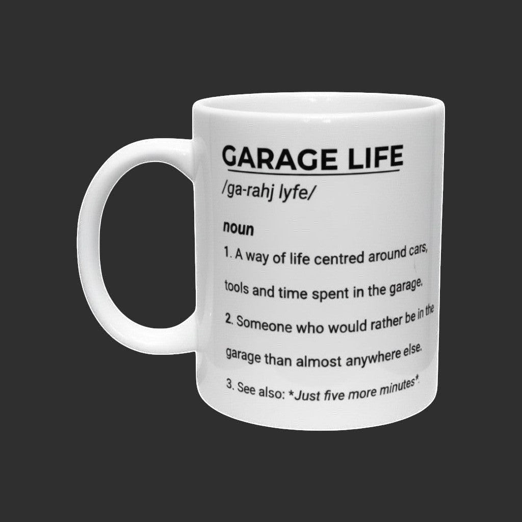 Illustrated Solutions Store white ceramic mug with black text defining "Garage Life" as a way of life centered around cars and tools.