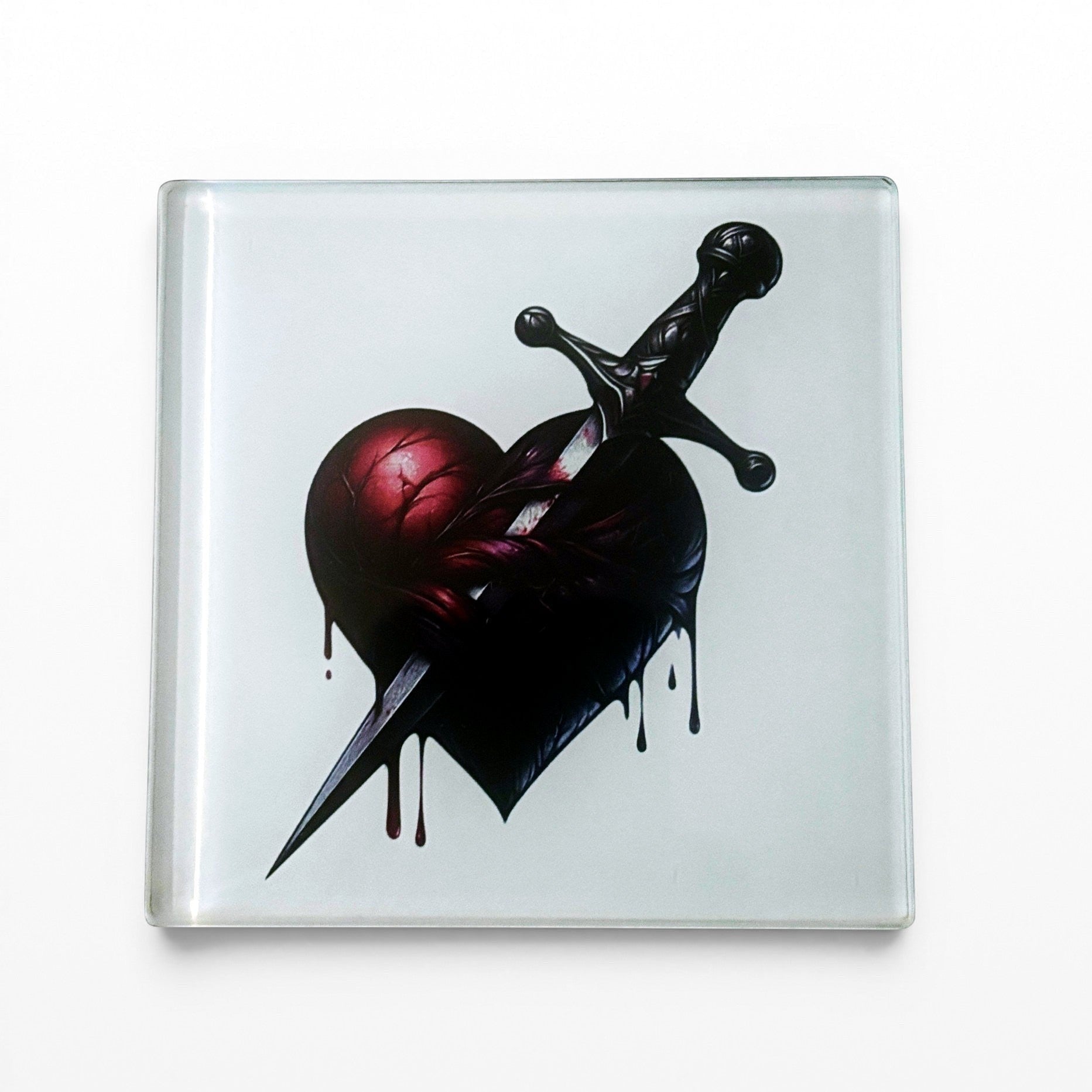 Illustrated Solutions Store gothic glass coaster with a dark heart pierced by a dagger, dripping blood.