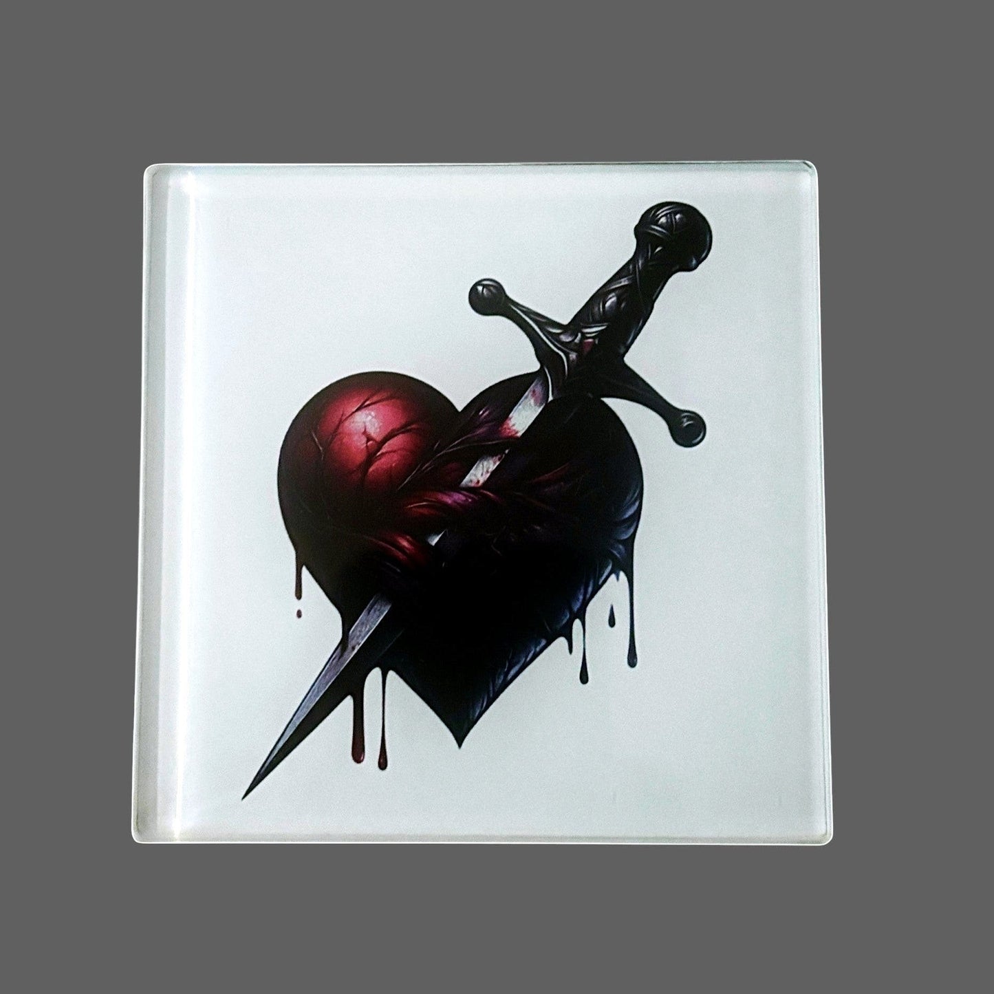 Illustrated Solutions Store gothic heart dagger glass square coaster. Features a dark, dripping heart pierced by a dagger.
