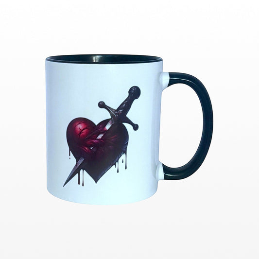 Illustrated Solutions Store white ceramic mug with black handle and interior, featuring a dark gothic heart pierced by a dagger.