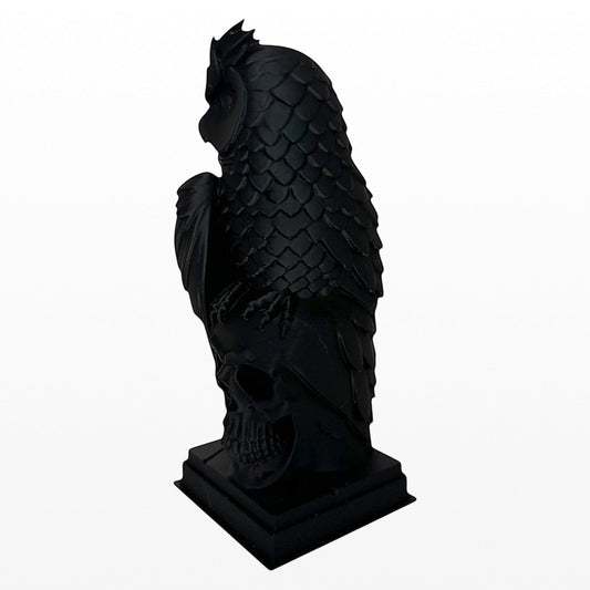 Illustrated Solutions Store black gothic owl figurine perched on a skull base, detailed feathers, solid construction.