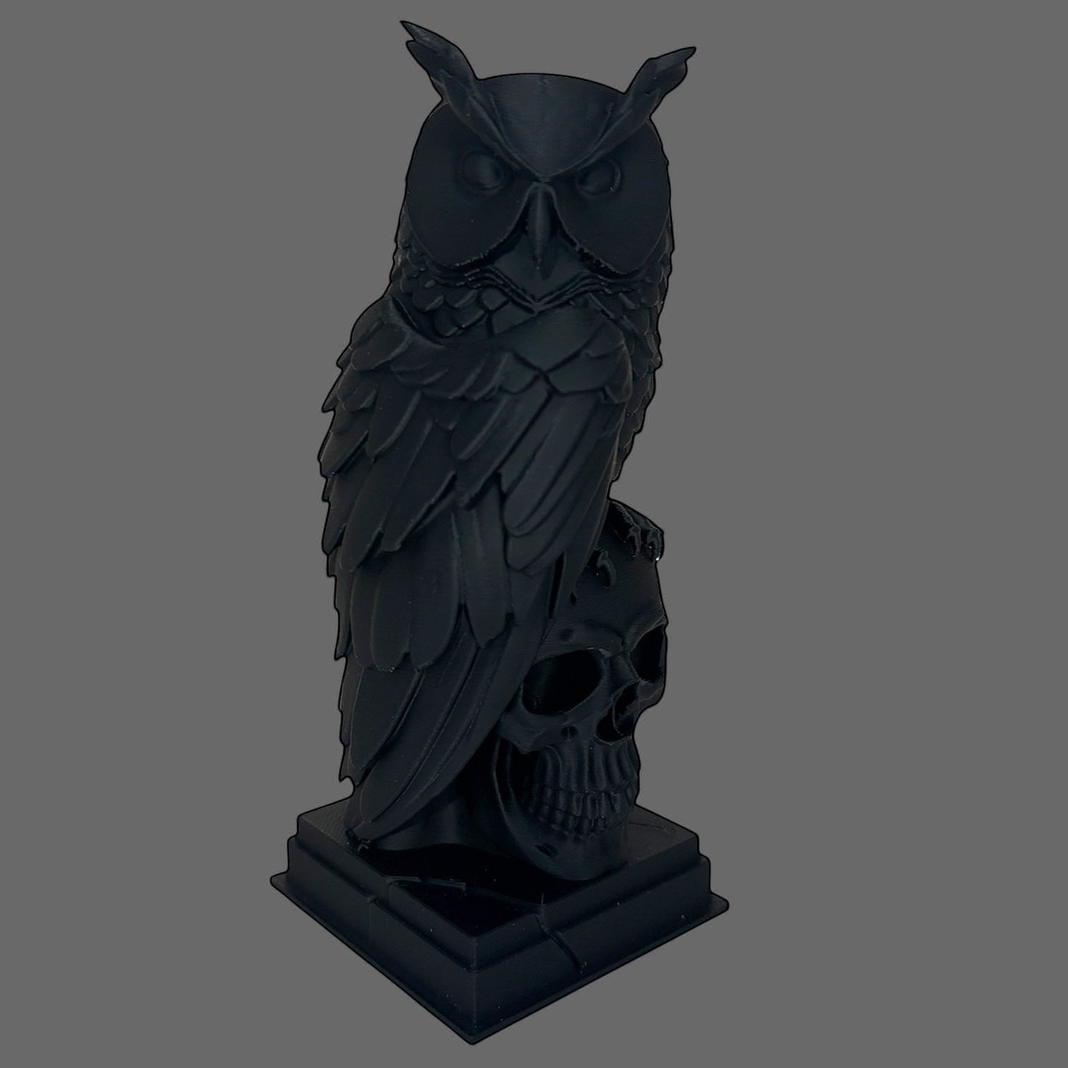 Illustrated Solutions Store black gothic owl figurine perched on a detailed skull, with layered feather detail and a solid base.