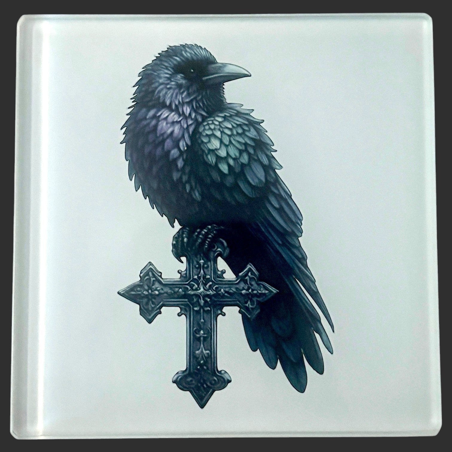 Illustrated Solutions Store square glass coaster featuring a black raven perched on an ornate gothic cross. Close-up view.